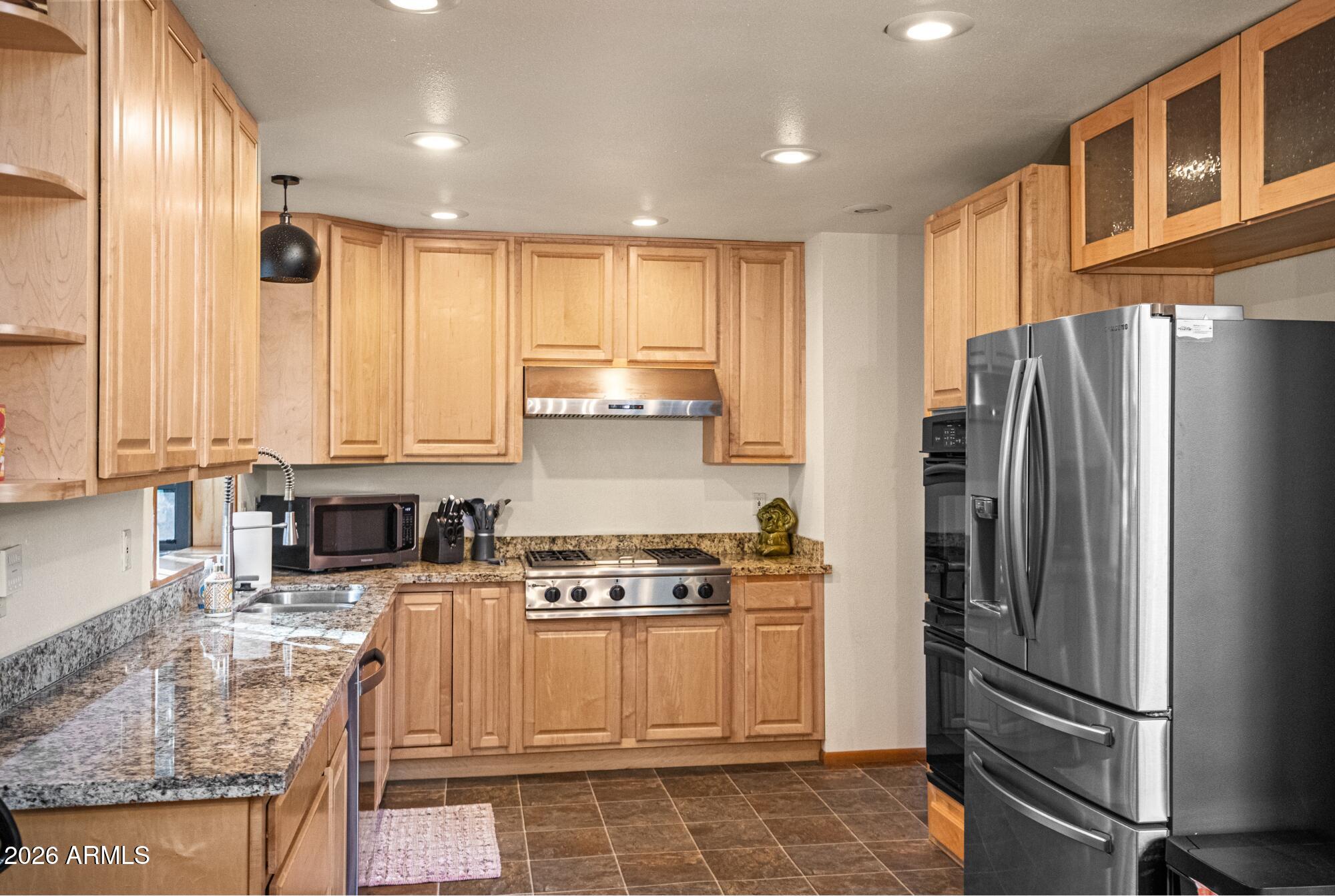 628 Trout Springs Road Forest Lakes, AZ 85931 - Photo 13 of 49 a kitchen with stainless steel appliances granite countertop a refrigerator sink and stove