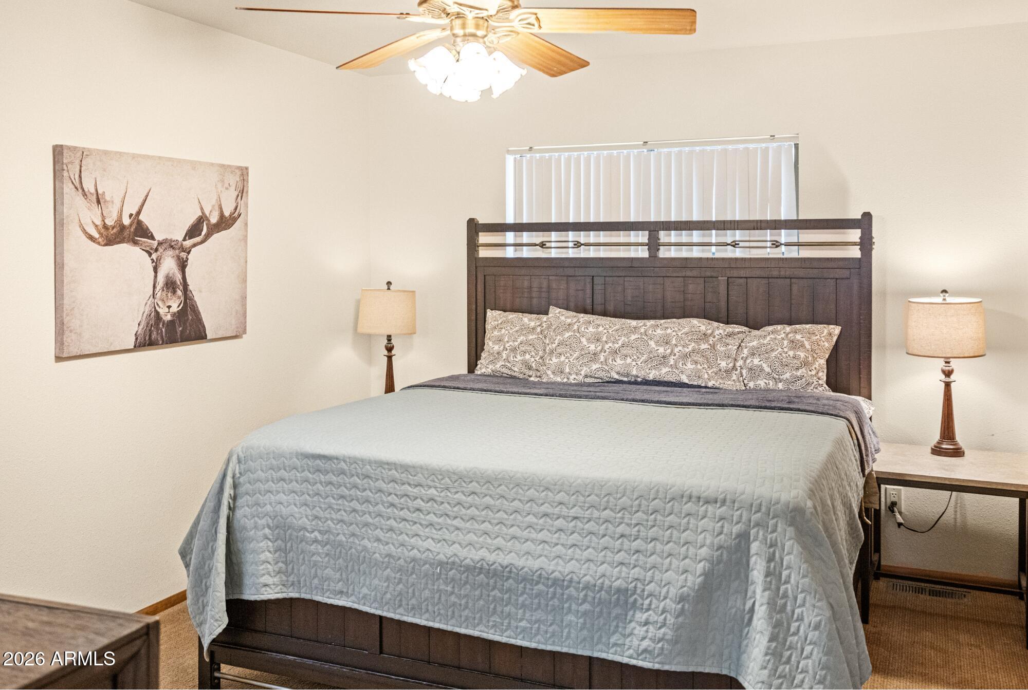 628 Trout Springs Road Forest Lakes, AZ 85931 - Photo 14 of 44 a bedroom with a bed and a night stand