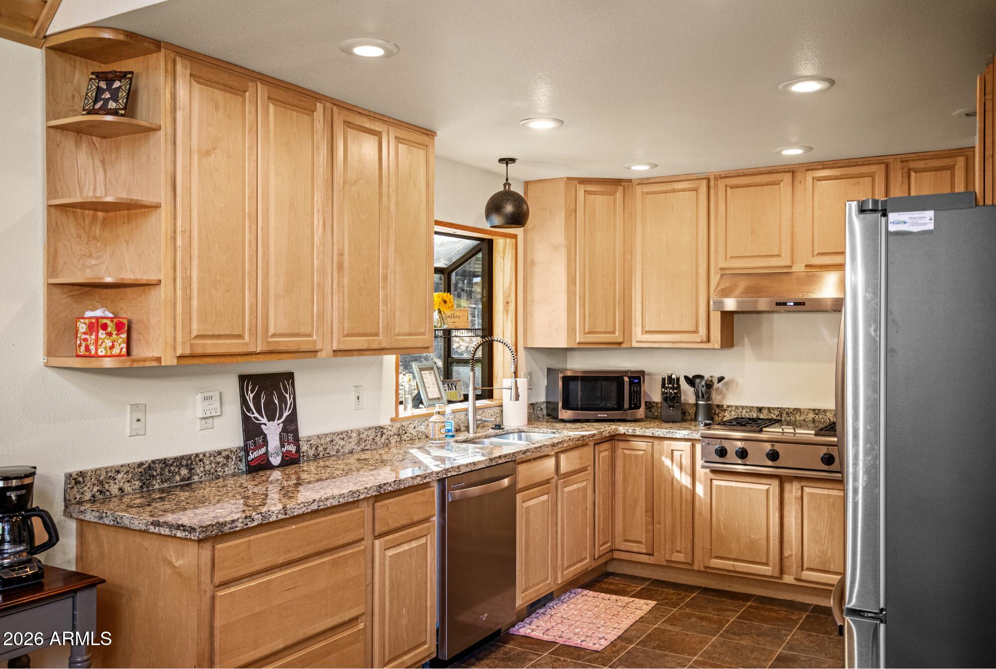 628 Trout Springs Road Forest Lakes, AZ 85931 - Photo 14 of 49 a kitchen with kitchen island granite countertop a sink stainless steel appliances and cabinets