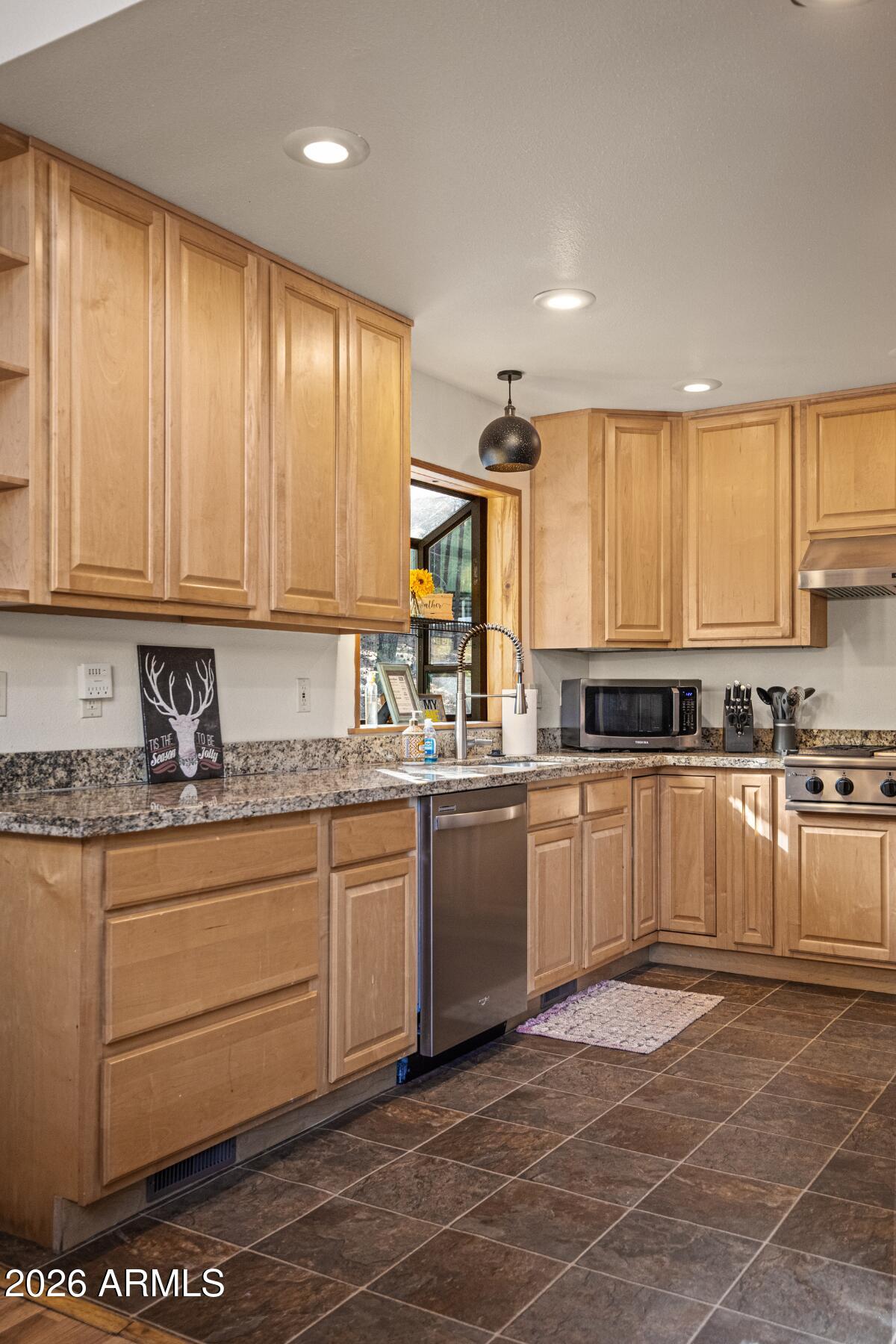 628 Trout Springs Road Forest Lakes, AZ 85931 - Photo 16 of 49 a kitchen with stainless steel appliances granite countertop a stove a sink and a microwave