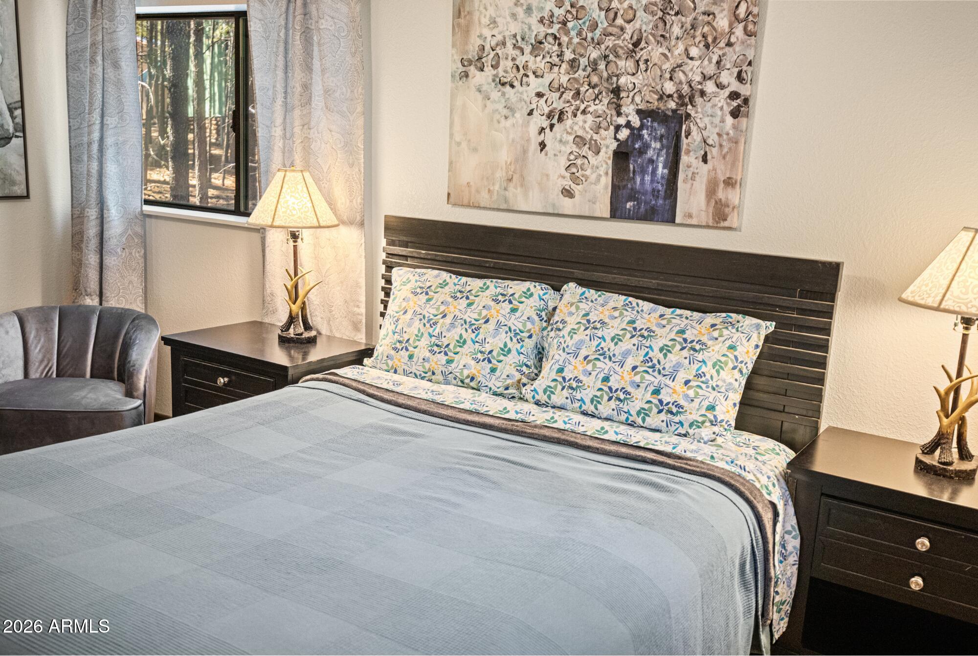 628 Trout Springs Road Forest Lakes, AZ 85931 - Photo 19 of 44 a bed sitting in a bedroom next to a window