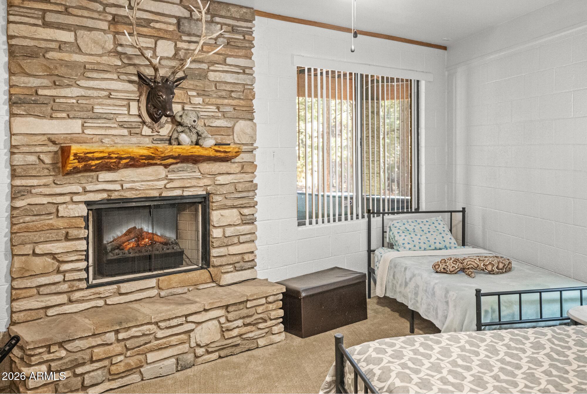 628 Trout Springs Road Forest Lakes, AZ 85931 - Photo 24 of 44 a bedroom with a bed a fireplace and a window