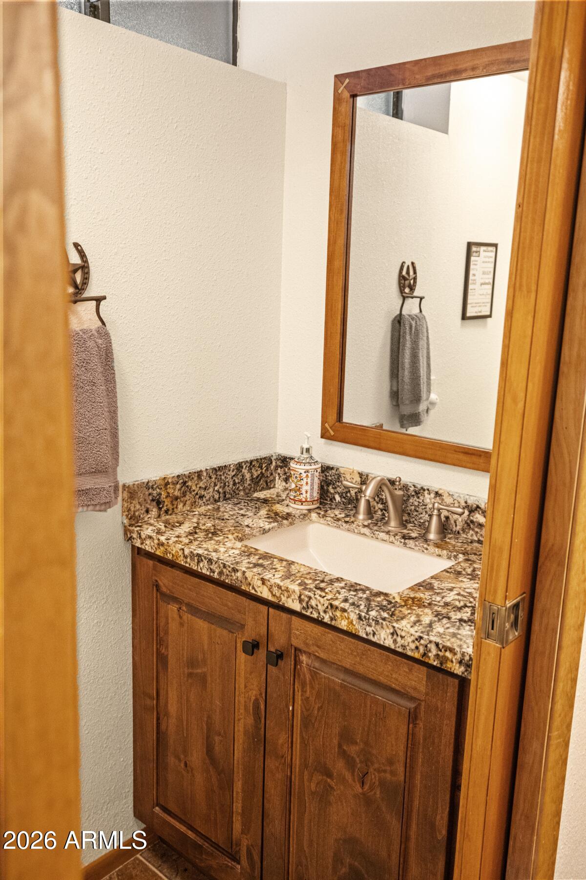 628 Trout Springs Road Forest Lakes, AZ 85931 - Photo 29 of 49 a bathroom with a granite countertop sink and a mirror