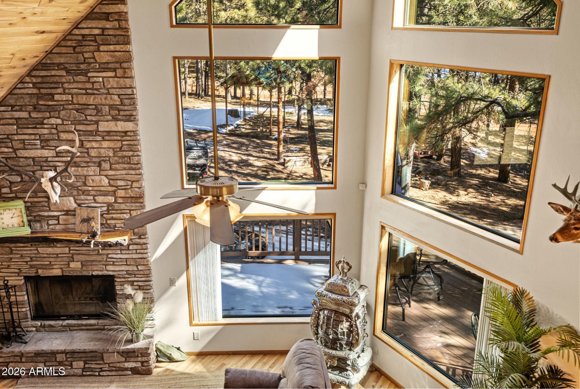 628 Trout Springs Road Forest Lakes, AZ 85931 - Photo 3 of 44 a living room with a fireplace and windows