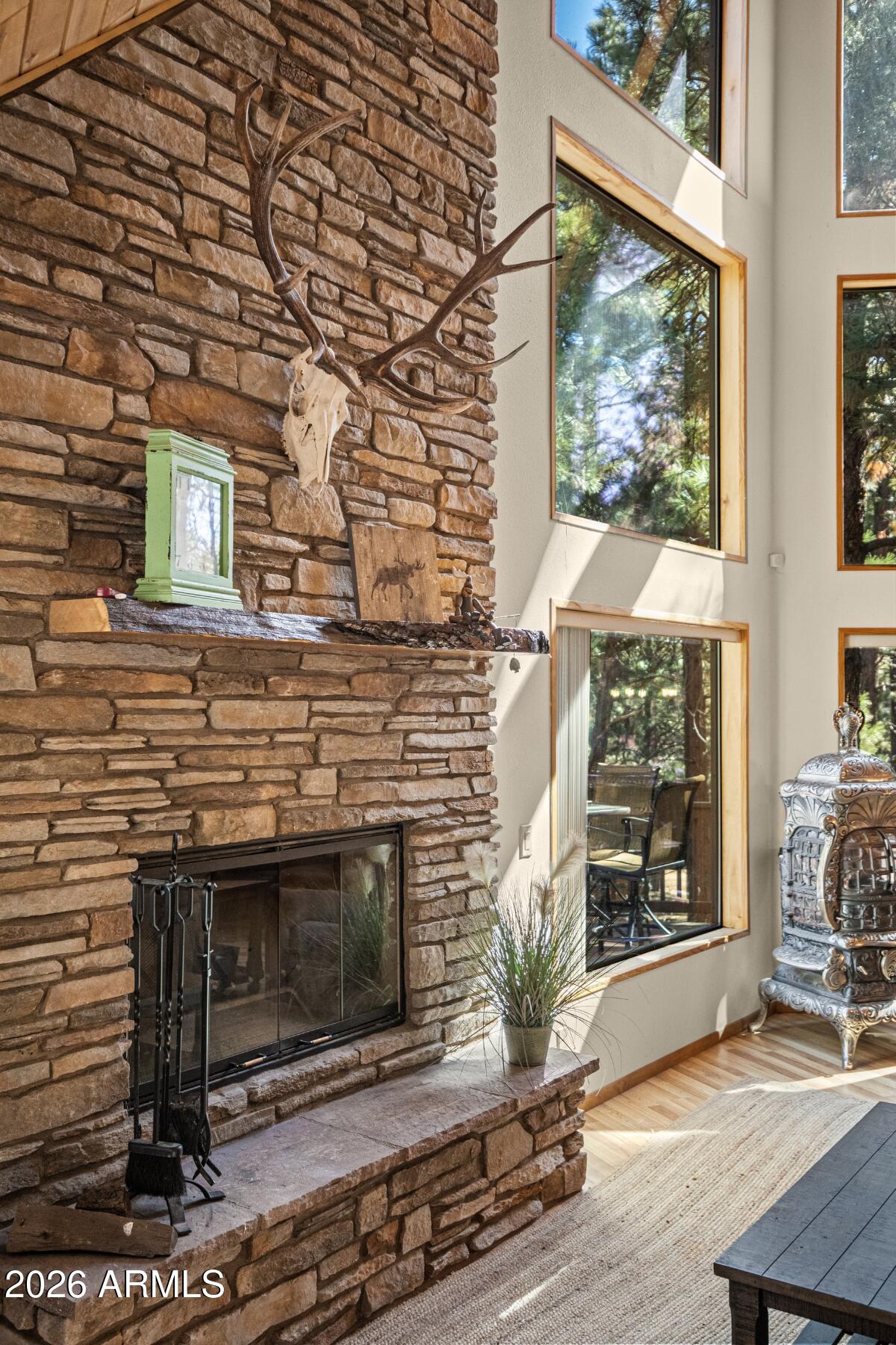 628 Trout Springs Road Forest Lakes, AZ 85931 - Photo 38 of 49 a living room with a fireplace wooden floor and a window
