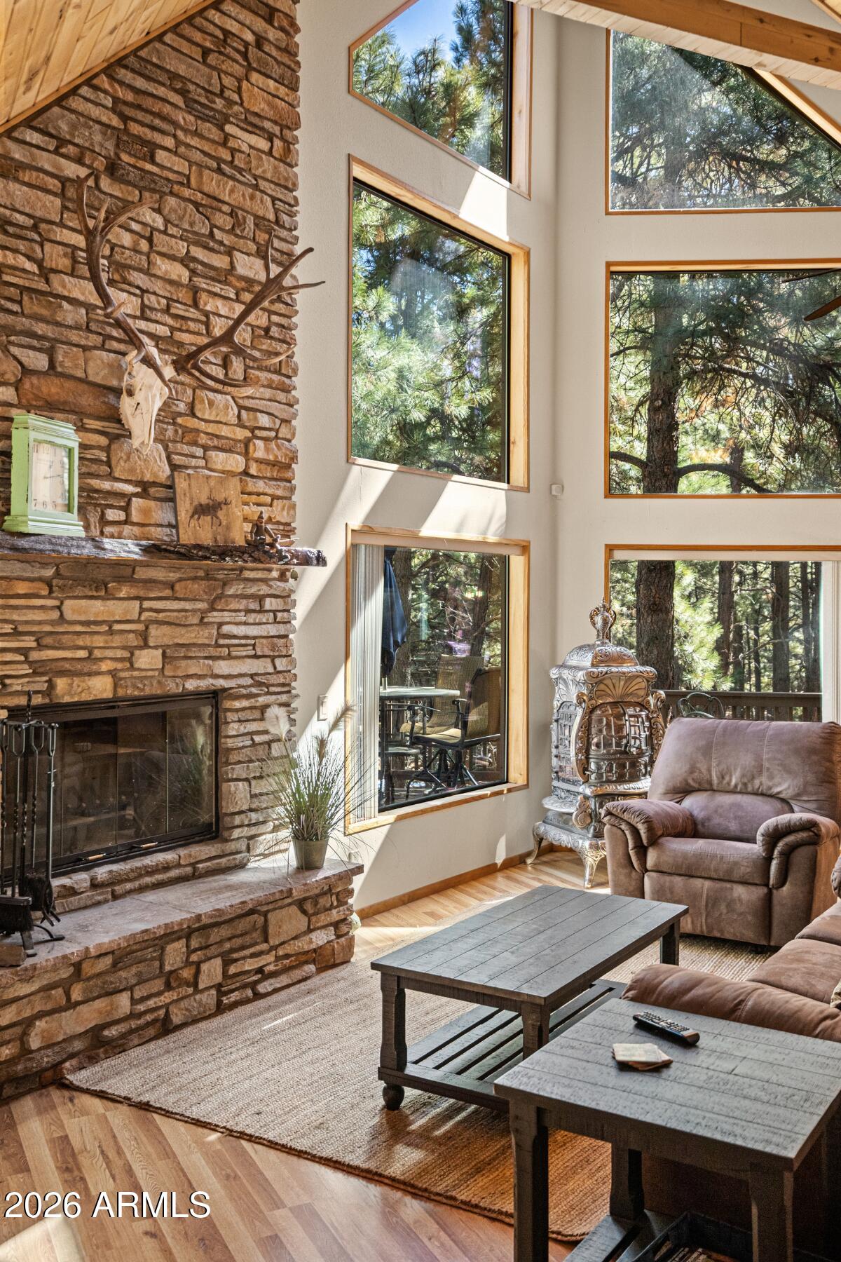 628 Trout Springs Road Forest Lakes, AZ 85931 - Photo 39 of 49 a living room with furniture a window and a fireplace