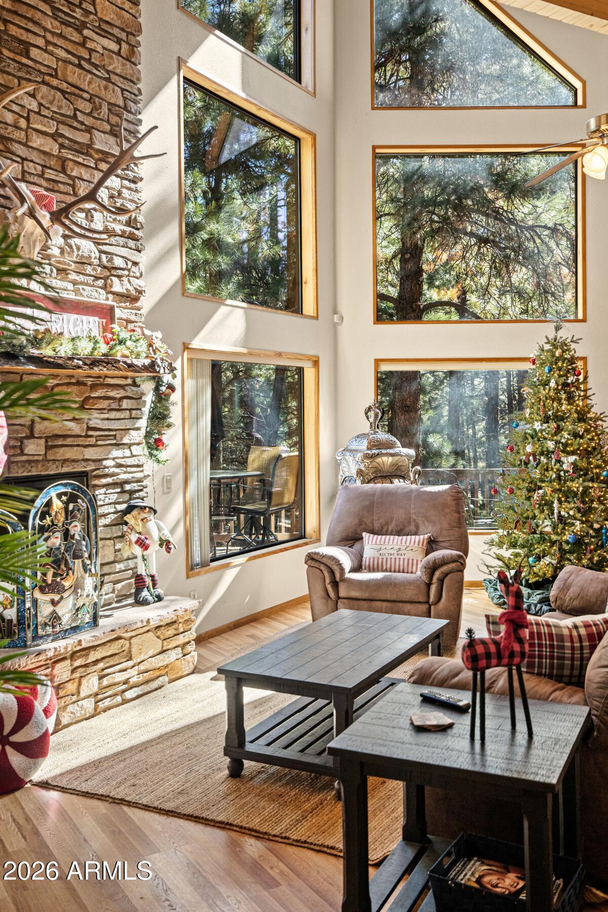 628 Trout Springs Road Forest Lakes, AZ 85931 - Photo 40 of 44 a living room with furniture a table and a large window