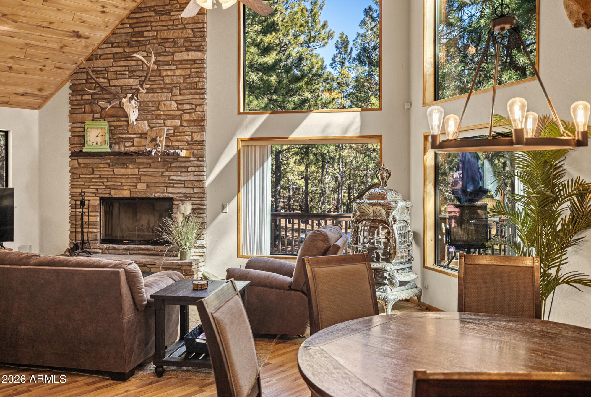628 Trout Springs Road Forest Lakes, AZ 85931 - Photo 4 of 44 a view of a dining room with furniture window and outside view