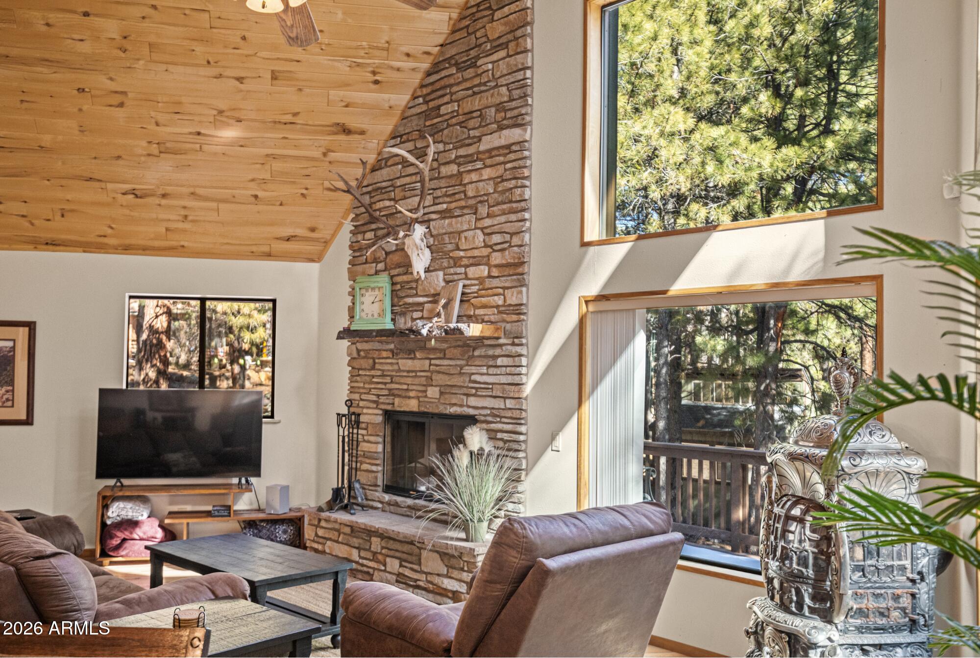 628 Trout Springs Road Forest Lakes, AZ 85931 - Photo 7 of 44 a living room with furniture a flat screen tv and a fireplace