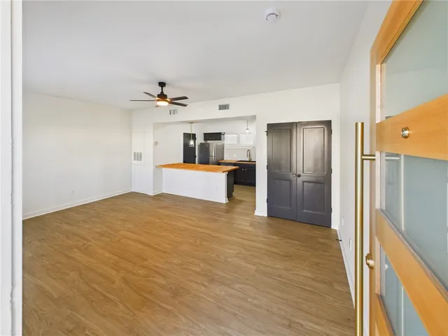 a view of a kitchen with wooden floor and a kitchen