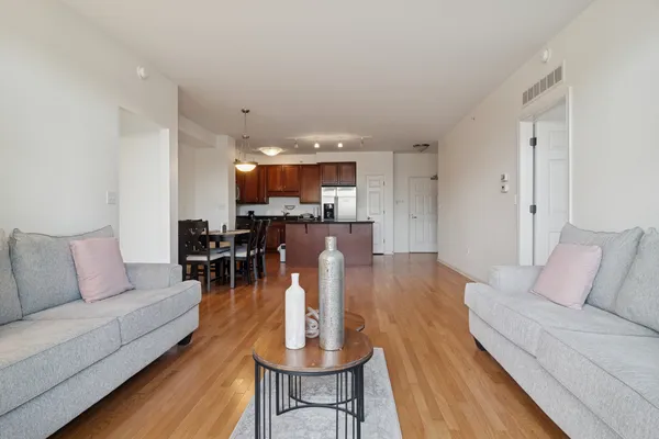 a living room with furniture and a wooden floor