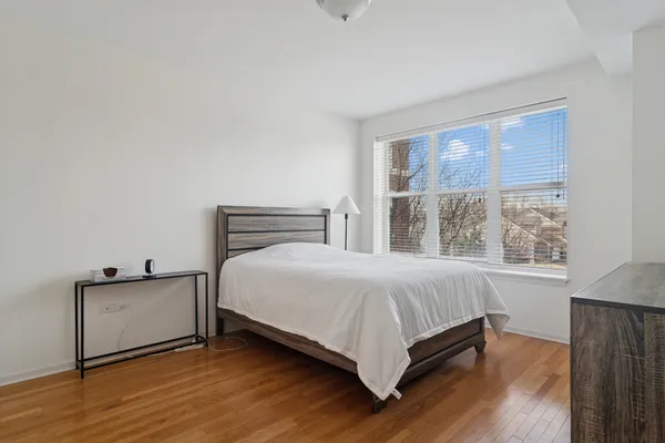 a bedroom with a bed and window