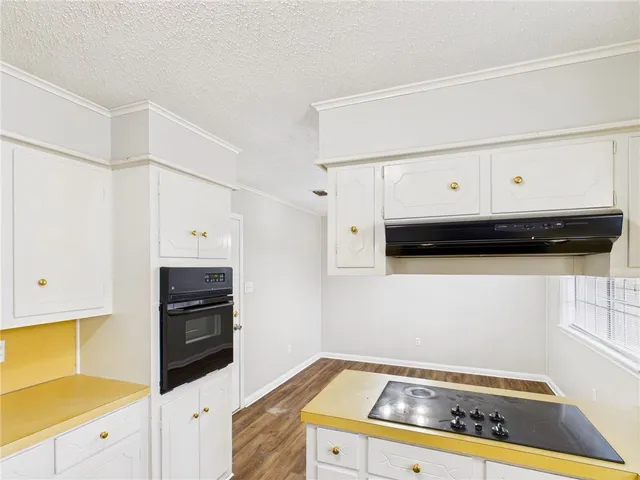 a kitchen with granite countertop a stove and a cabinets