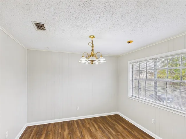 a view of a room with wooden floor and a window