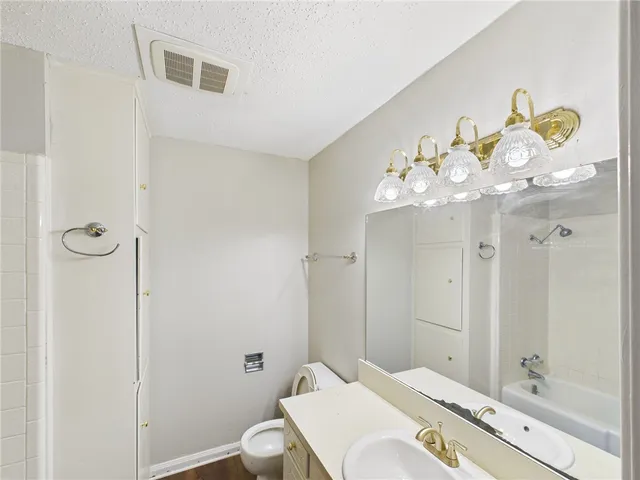 a bathroom with a sink mirror and a bathtub