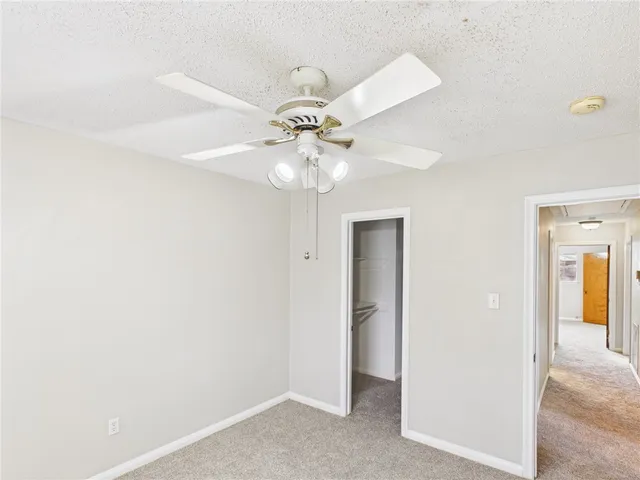 a view of a chandelier fan and entryway