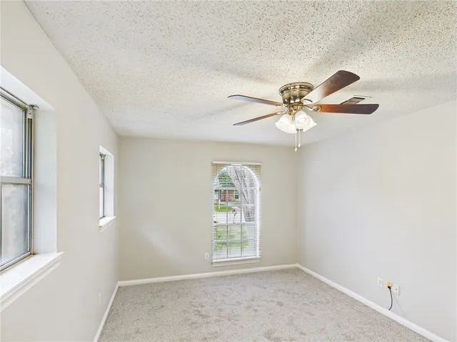 a view of a livingroom with a ceiling fan and window