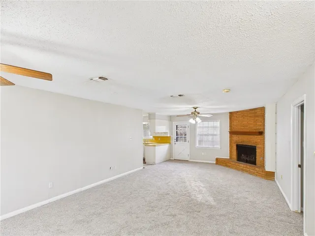 a view of empty room with fireplace and entryway