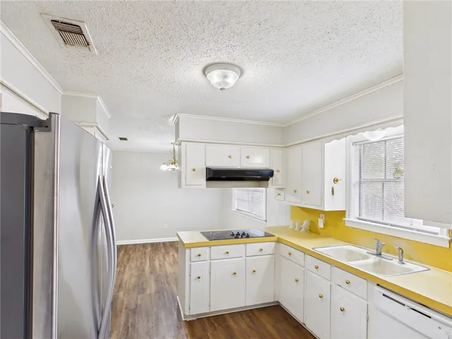a kitchen with a sink stove and refrigerator