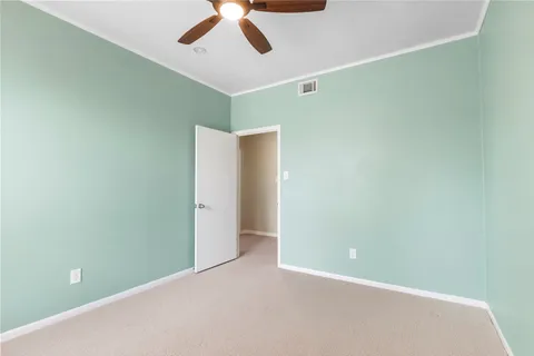 an aerial view of residential houses with outdoor space and trees