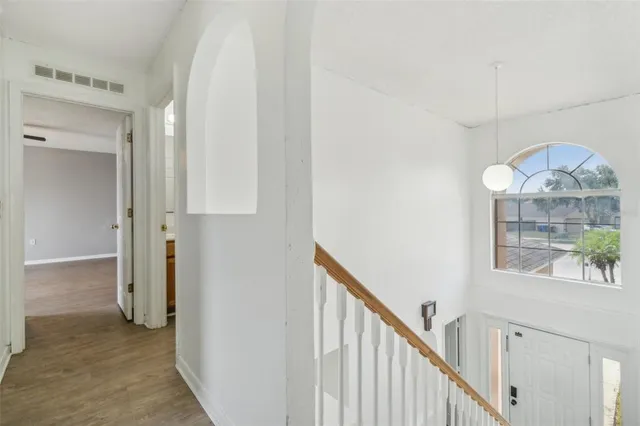 a view of an entryway with wooden floor