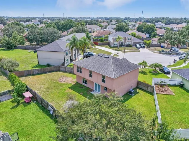 an aerial view of a house with garden space and street view