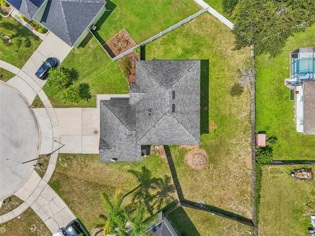 an aerial view of residential houses with outdoor space and swimming pool