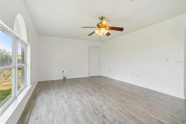a view of a room with wooden floor and fan