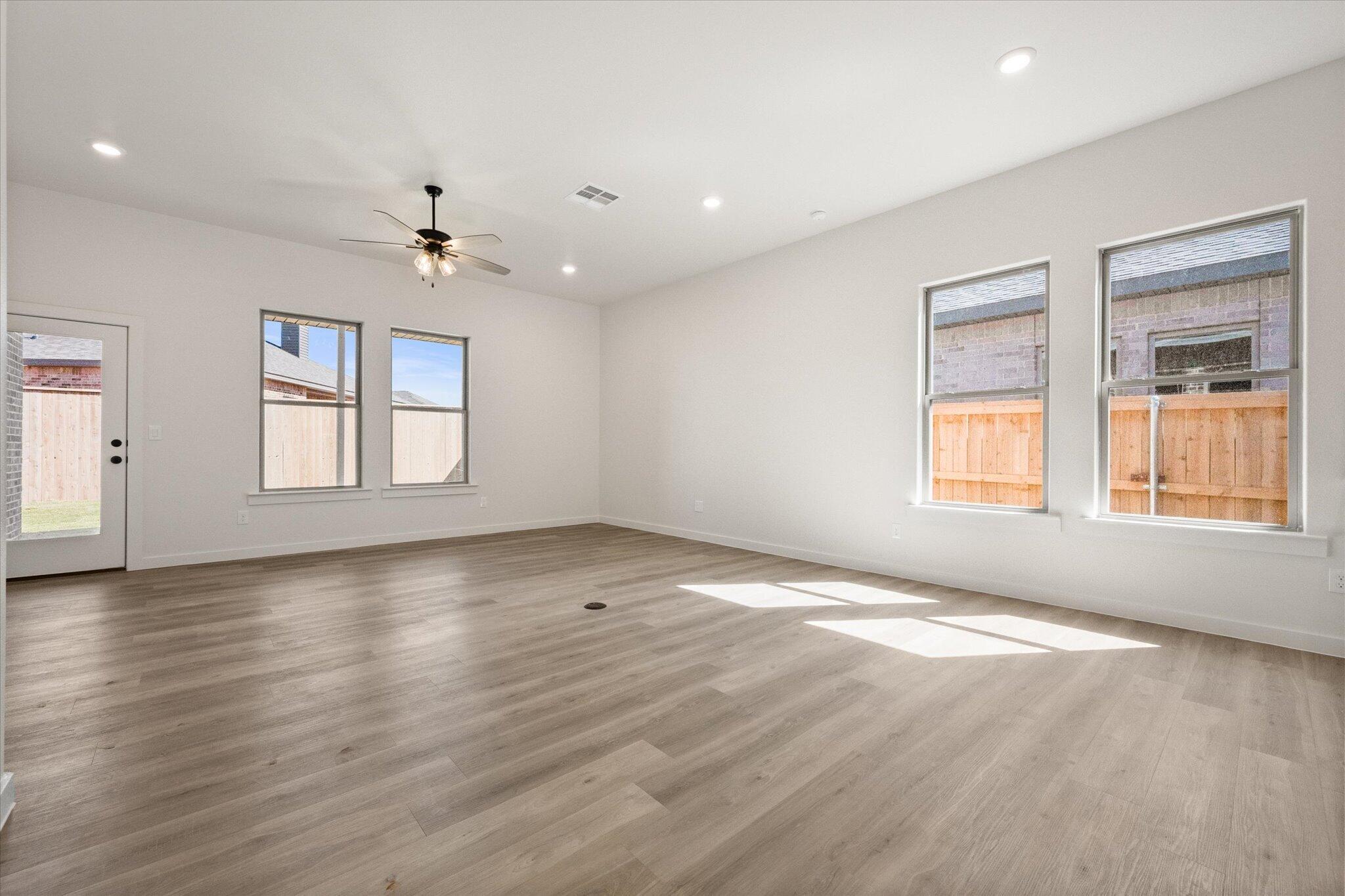 7003 53rd Street Lubbock, TX 79407 - Photo 4 of 25 an empty room with wooden floor and windows