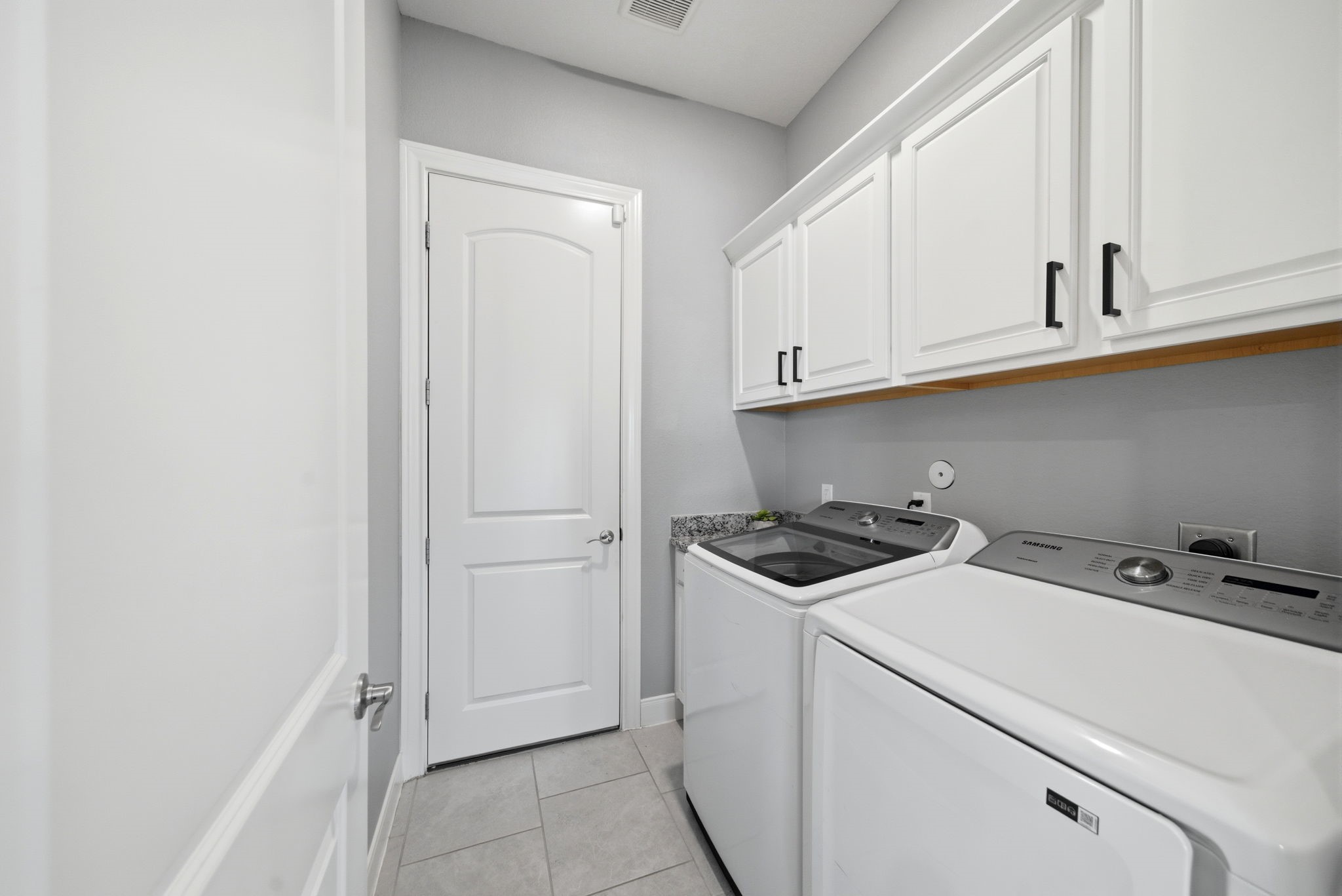 129 Magnolia Reserve Loop Magnolia, TX 77354 - Photo 11 of 34 Laundry room just off the kitchen area that leads to the 3-car garage.