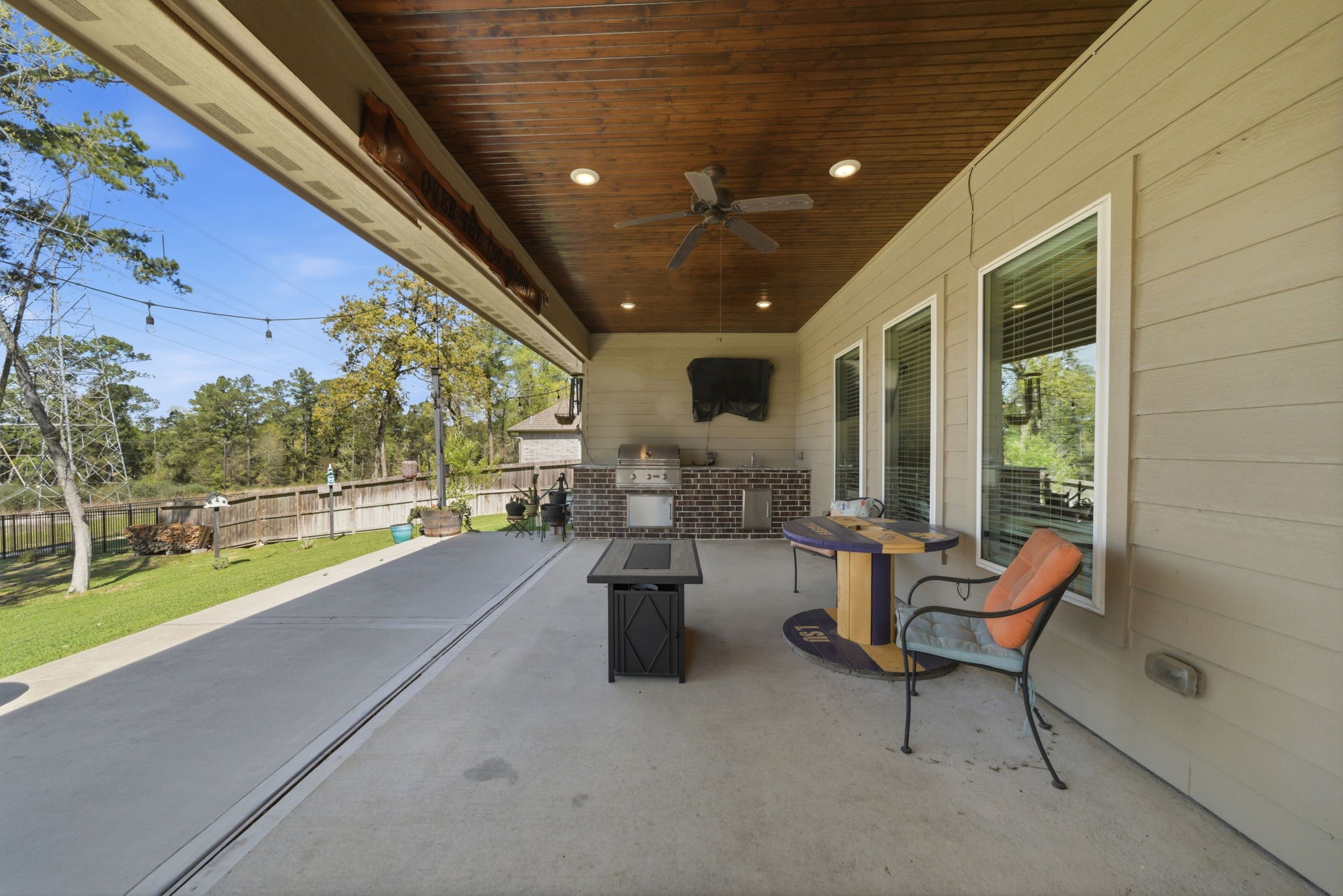 129 Magnolia Reserve Loop Magnolia, TX 77354 - Photo 26 of 34 Patio extension with string lights, natural wood beadboard ceiling and a built-in outdoor kitchen.