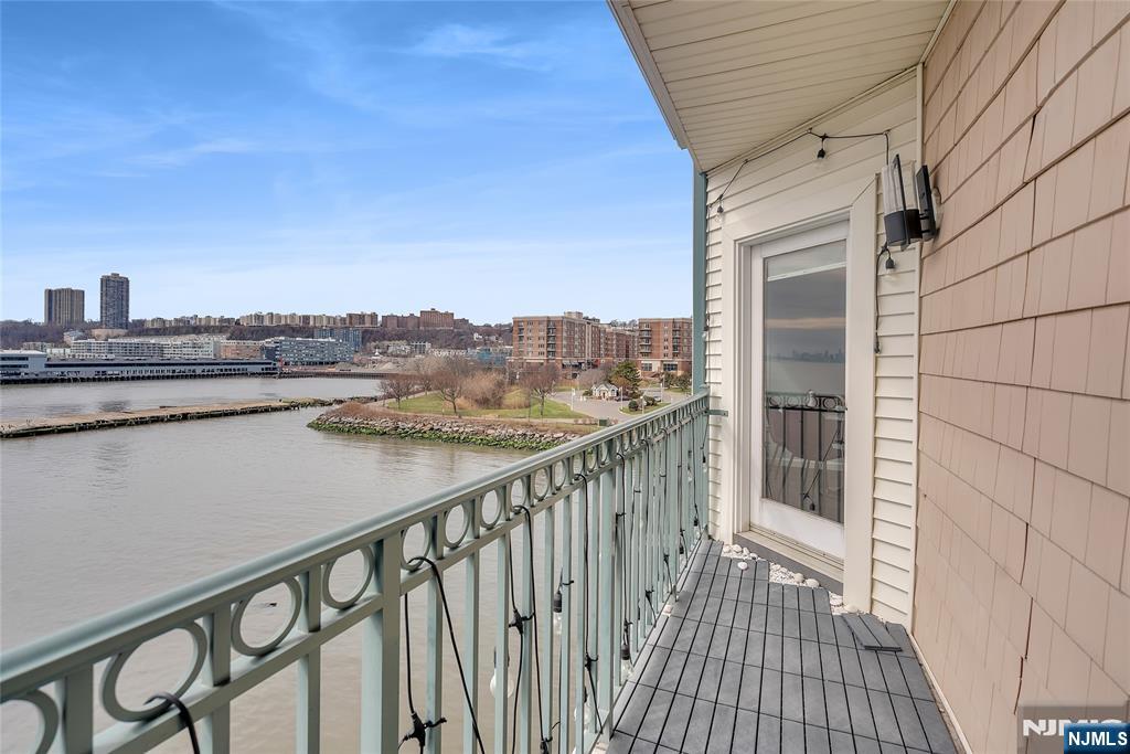 314 The Promenade Edgewater, NJ 07020 - Photo 18 of 37 a view of a balcony with wooden floor and fence