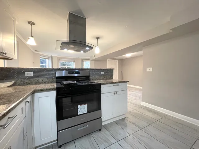 a kitchen with stainless steel appliances granite countertop a stove and a sink