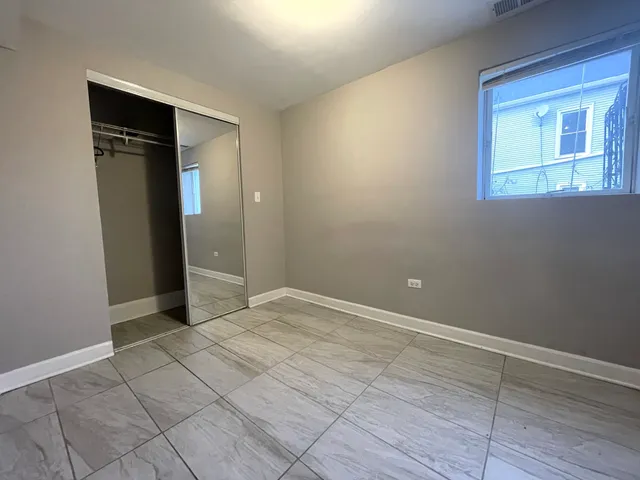 an empty room with wooden floor and closet