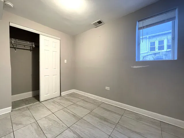 a view of an empty room with closet