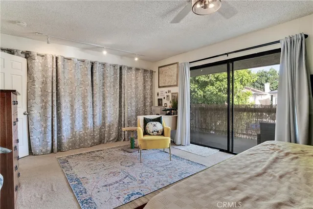a bedroom with a bed and large window