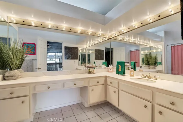 a large white bathroom with a sink mirror and view