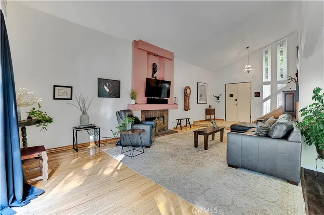 a living room with furniture a flat screen tv and a fireplace
