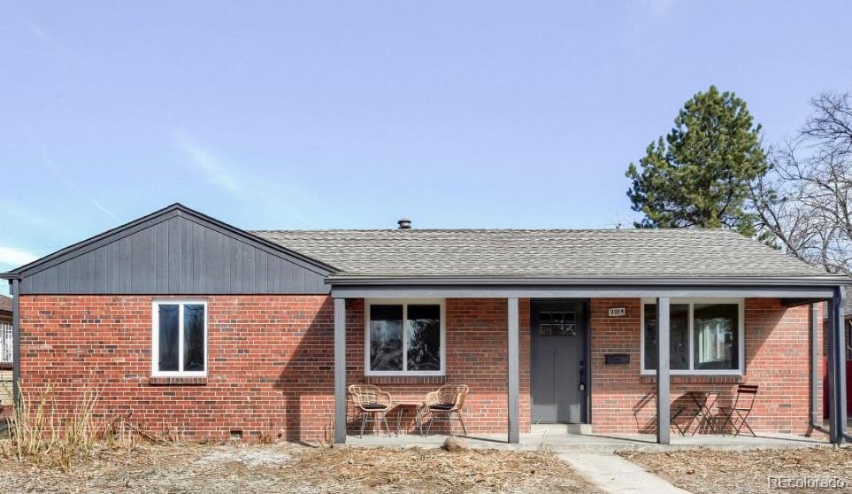 3014 Magnolia Street Denver, CO 80207 - Photo 1 of 16 a front view of a house with garden
