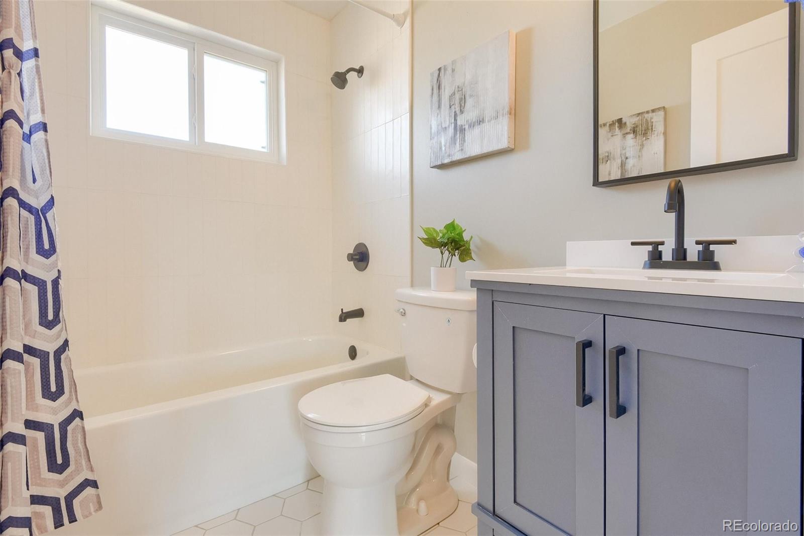 3014 Magnolia Street Denver, CO 80207 - Photo 14 of 16 a bathroom with a sink a toilet and shower
