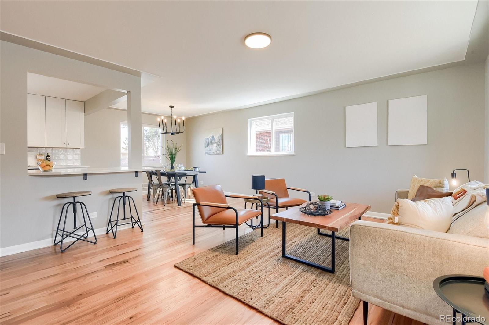 3014 Magnolia Street Denver, CO 80207 - Photo 2 of 16 a living room with furniture and wooden floor