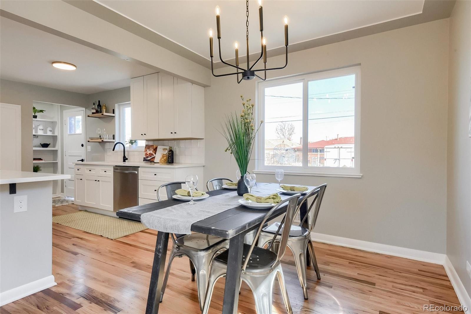 3014 Magnolia Street Denver, CO 80207 - Photo 9 of 16 a kitchen with kitchen island a table and chairs in it