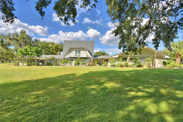 a living room with furniture a rug and a window