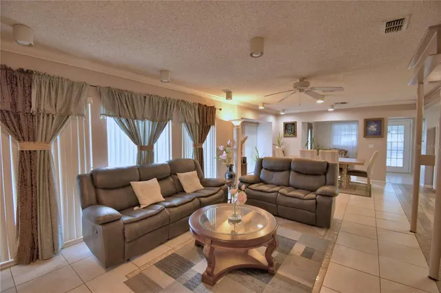 a kitchen with granite countertop a stove a microwave a sink and cabinets