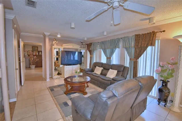 a living room with furniture large window and flat screen tv