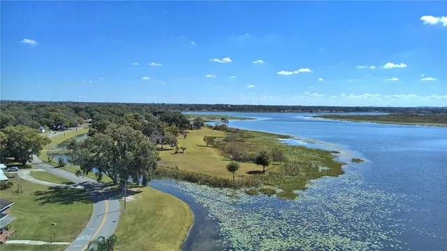 an aerial view of a residential houses with outdoor space and swimming pool