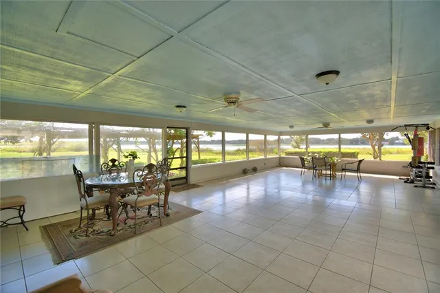 a bed sitting in a spacious bedroom next to a window