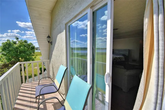 a spacious bedroom with a bed and a chandelier