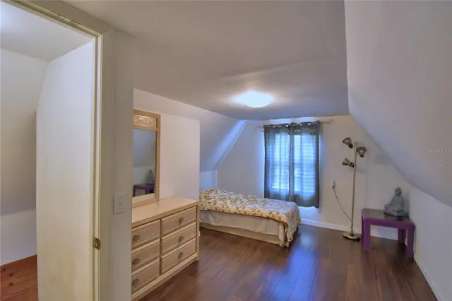 a view of a big yard with table and chairs and a fire pit