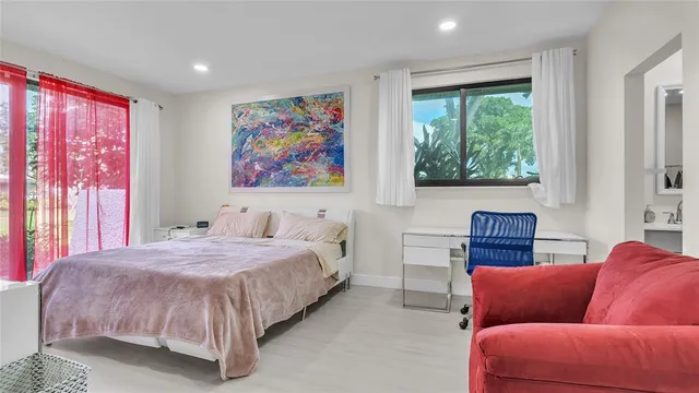 a bedroom with a bed couch and window